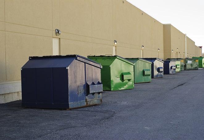 metallic dumpster units staged for construction garbage in Bryan